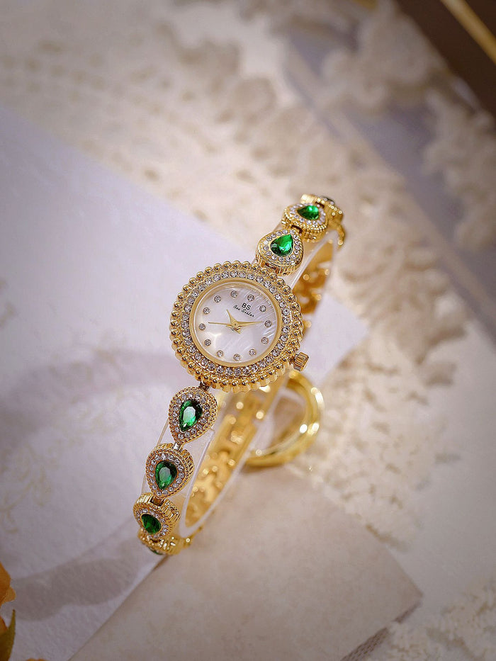 Mother of pearl teardrop watch gold link green gems