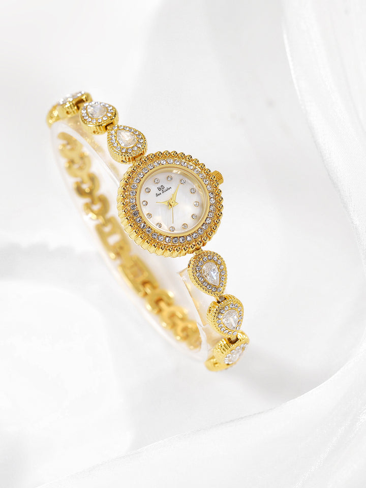 Mother of pearl teardrop watch gold link white gems white face