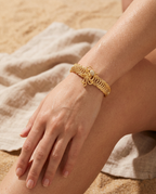 Gold marine starfish bangle worn on the wrist, coastal summer