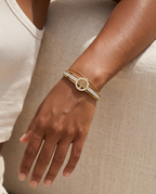 Gold Tree of Life zircon bangle worn on the wrist, summer
