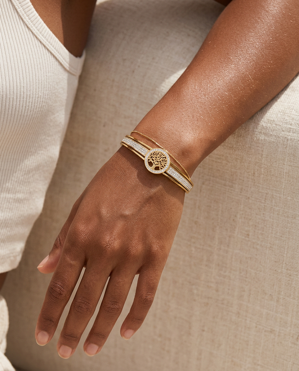 Gold Tree of Life zircon bangle worn on the wrist, summer