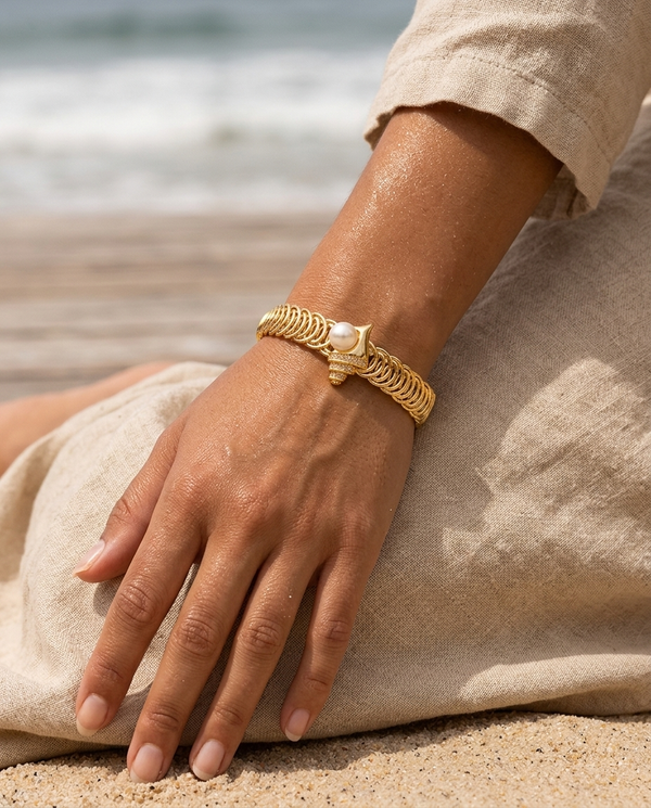 Gold marine seahorse bangle worn on the wrist, coastal summer