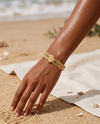 Gold marine starfish and shell bangle worn on the wrist, coastal summer