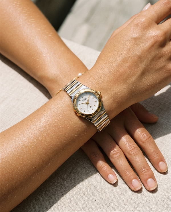Champagne-gold fluted-bezel Roman-marker watch worn on the wrist, summer